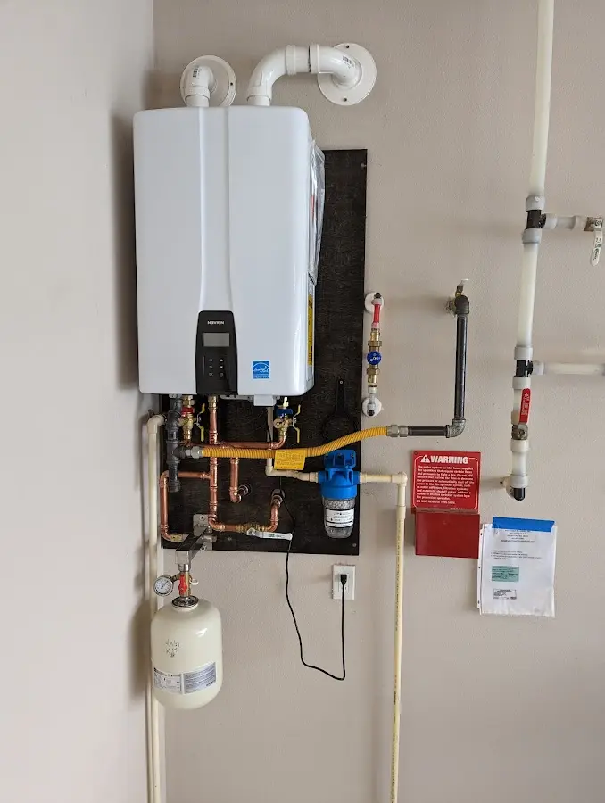 Professional plumber installing copper piping in a New Whiteland home